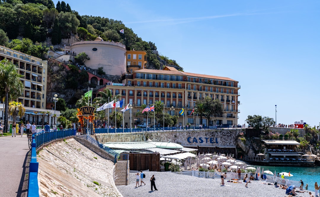 Coastal city with a grand hotel overlooking a sunny beach.