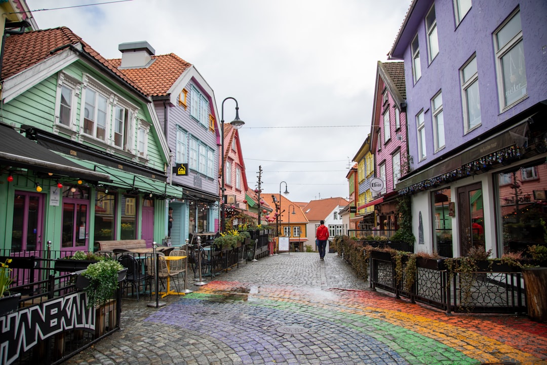 Colorful buildings line a cobblestone street with rainbow colors.